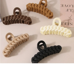 Flat lay of 11cm matte chain hair claws in brown, khaki, cream, and black colors