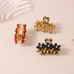 Tre eleganti fermagli per capelli con fiori di perle nei colori rosso, oro e nero con cuore