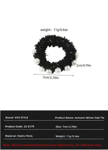 Detailed view of black velvet scrunchie with pearls showing 7cm diameter and 2cm width
