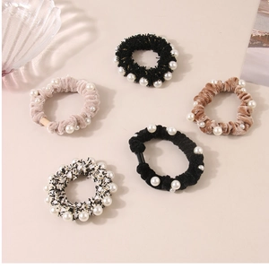 Set of five elegant velvet and tweed scrunchies with white pearl edges in neutral tones