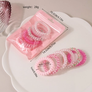 Détail de 6 élastiques cheveux spirale roses avec motifs étoiles en emballage transparent