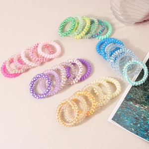 Lot de 6 chouchous spirales colorés aux couleurs acidulées avec motifs d'étoiles