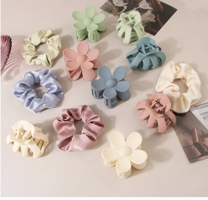 Flat lay of Morandi fabric hair ties and matte claw clips with floral patterns