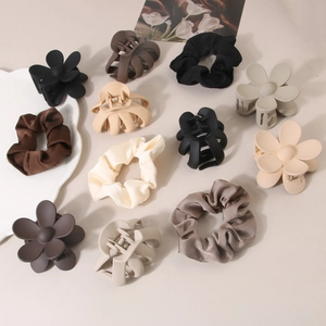 Elegant hair accessory set with matte flower claws and silk scrunchies in earth tones