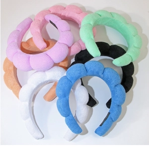 Collection of seven colorful puffy spa headbands in soft coral fleece fabric