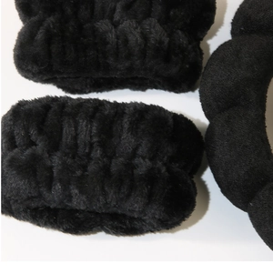 Close-up of black coral fleece face wash headband and wristband set for skincare