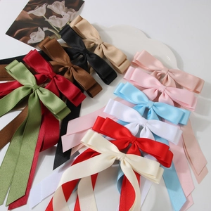 Elegant multi-color double-layered satin bow hair clips with long ribbons in a tray