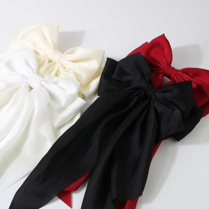 Oversized satin ribbon bow hair clips set in black, red, white, and cream colors