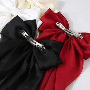 Oversized satin bow hair clips in black red and cream white with metal spring fastener