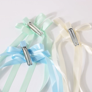 Three long ribbon bow hair clips in mint green cream yellow and sky blue colors