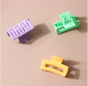 Three colorful matte candy-colored rectangular hair claw clips for versatile styling