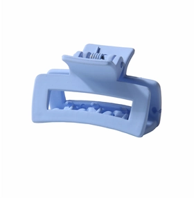 Detail view of a matte light blue rectangular hollow hair claw clip with a metal spring