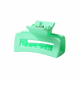 Macro side view of matte mint green square hollow hair claw clip with metal spring