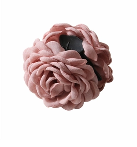 Close-up detail of the pink fabric layers and linen texture on this large rose hair claw