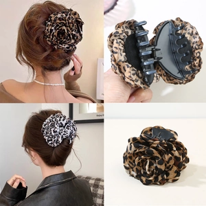 Detailed views of large leopard print rose flower hair claw clips for elegant hair styling