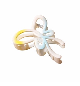 Detail view of cream butterfly hair claw clip with yellow and blue gradient resin finish