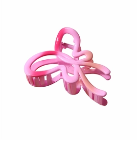 Detail view of large butterfly hair claw clip with pink gradient finish and silver spring