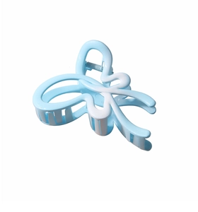 Macro view of blue butterfly hair claw clip with gradient colors and silver spring