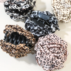 Five leopard print flower hair claws in multiple colors on a clean white background