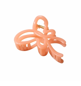 Detailed view of pink butterfly hair claw clip with golden metal spring mechanism