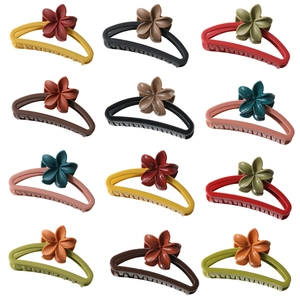 Set of 12 matte plumeria flower hair claws in various vibrant colors for thick hair