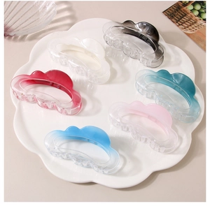 Cloud-shaped matte claw clips in various colors displayed on a white decorative tray