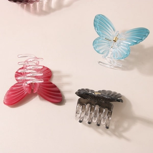 Three-piece set of elegant butterfly hair claw clips in blue, red, and gradient grey