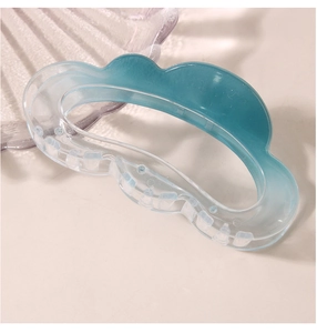 Detail of creative cloud-shaped hair claw in ice blue gradient with scalloped edges
