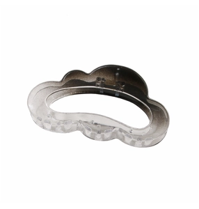 Detail of a wave-shaped cloud hair claw clip with a transparent brown gradient finish