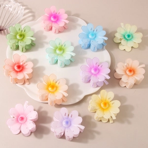 Macro shot of colorful gradient flower hair claws in various sweet macaron colors