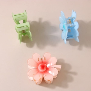 Three colorful floral hair claws in green, blue, and pink gradient with matte finish