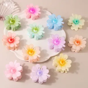 Colorful floral matte hair claws for women in various pastel gradient shades on a tray
