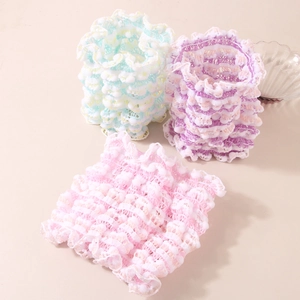 Three elastic knit U-shaped headbands in pastel macaron colors with soft ruffle texture