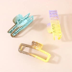 Three geometric gradient hair claws in teal and yellow matte resin for long hair styling