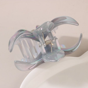 Detail view of iridescent flower claw clip showing Aurora AB colors and steel spring