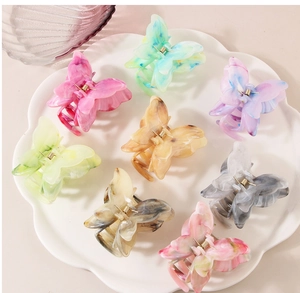 Detailed view of butterfly claw clips in eight marble patterns and colorful colors