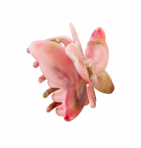 Close-up of butterfly hair claw clip with pink and green marble acetic texture