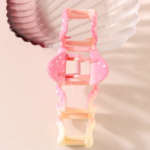 Large geometric wave hair claw clip featuring pink to cream yellow gradient with speckled design