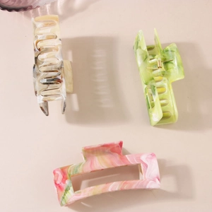 Three-piece large marble pattern hair claws in green, orange, and gray acrylic