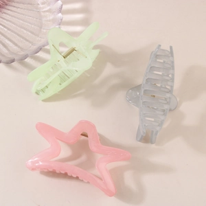 Three-piece Korean hair claw set with star and geometric shapes on pink background