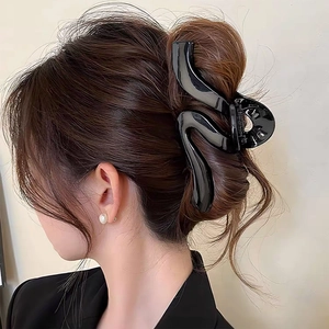 Elegant large black S-shaped wavy hair claw clip for thick hair styling in glossy finish