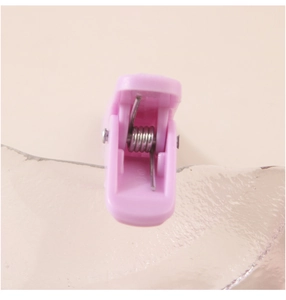 Macro shot of pink duckbill hair clip with durable internal metal spring mechanism