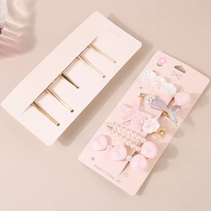 5-piece ocean theme hair clip set featuring starfish, shells, and pearls on display card