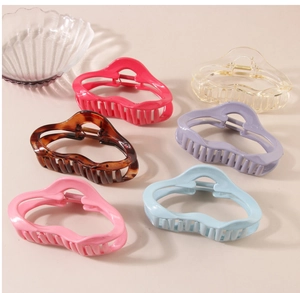 Set of six large wavy hair claw clips in various colors like pink, blue and tortoiseshell