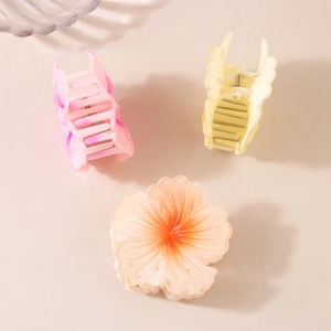 Three gradient floral hair claw clips in pink, purple, and yellow with matte finish
