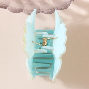 Light blue flower gradient hair claw clip with golden spring on a minimal background