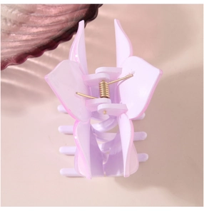 Macro detail of lavender flower hair claw clip with frosted finish and gold spring