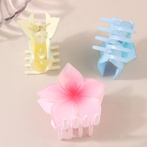 Three-piece frangipani hair claw clips in matte pastel pink, blue and green colors