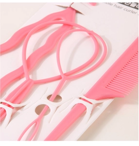 Close-up of pink plastic hair styling tools set including topsy tail and tail comb on card