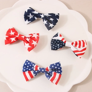 Set of 4 American flag pattern bow hair clips featuring stars and stripes on a white plate